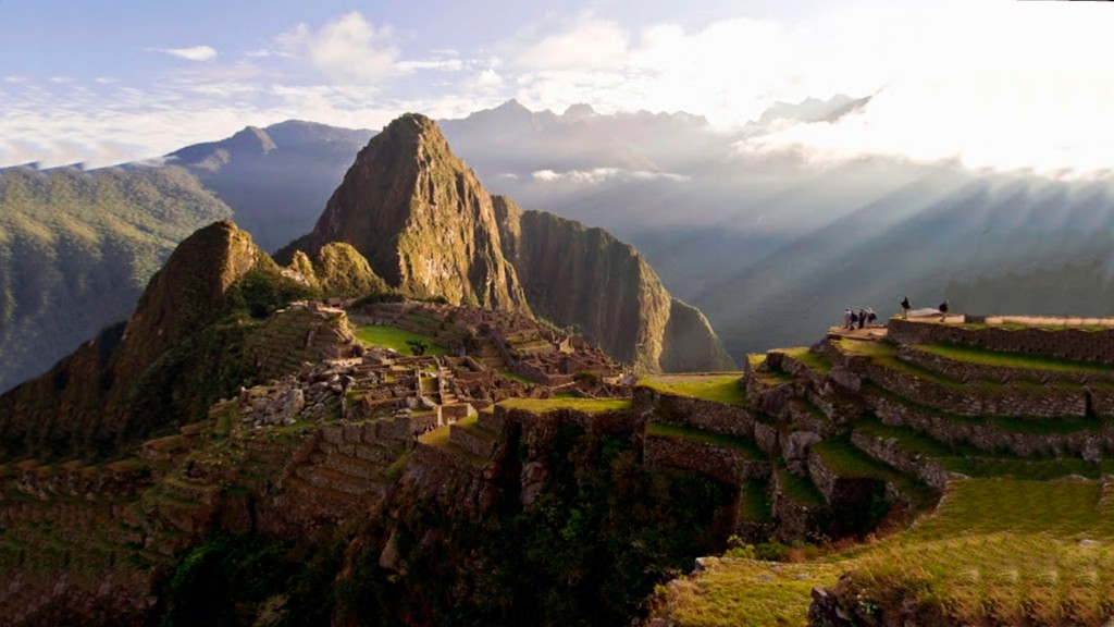 A group of people standing on top of a mountain.