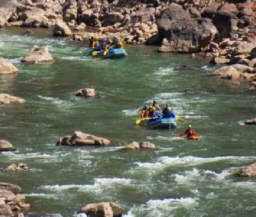 A group of people in rafts on the river.