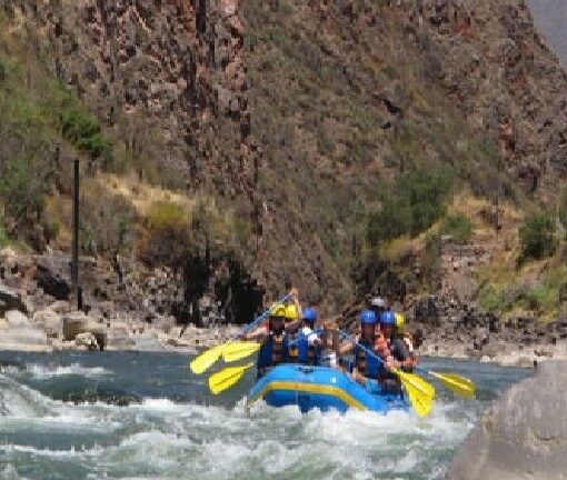 A group of people in a raft on the river.