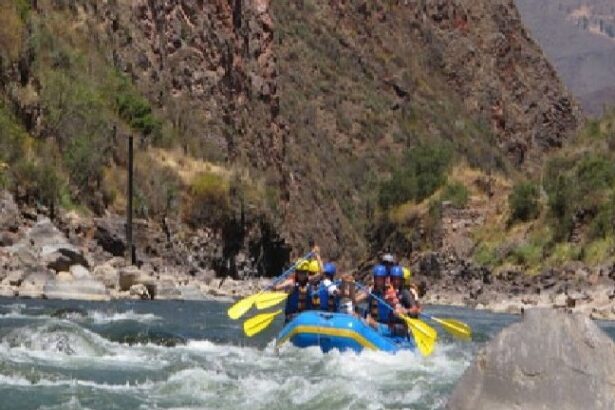 A group of people in a raft on the river.