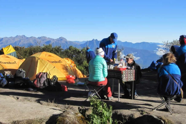 Hikers enjoying a meal with mountain views.