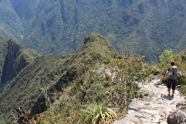 Hiker on mountain trail with stunning views.