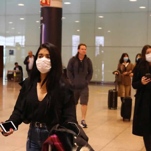 Masked travelers at an airport.