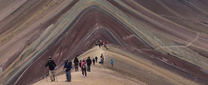 Rainbow Mountain hikers on scenic trail.